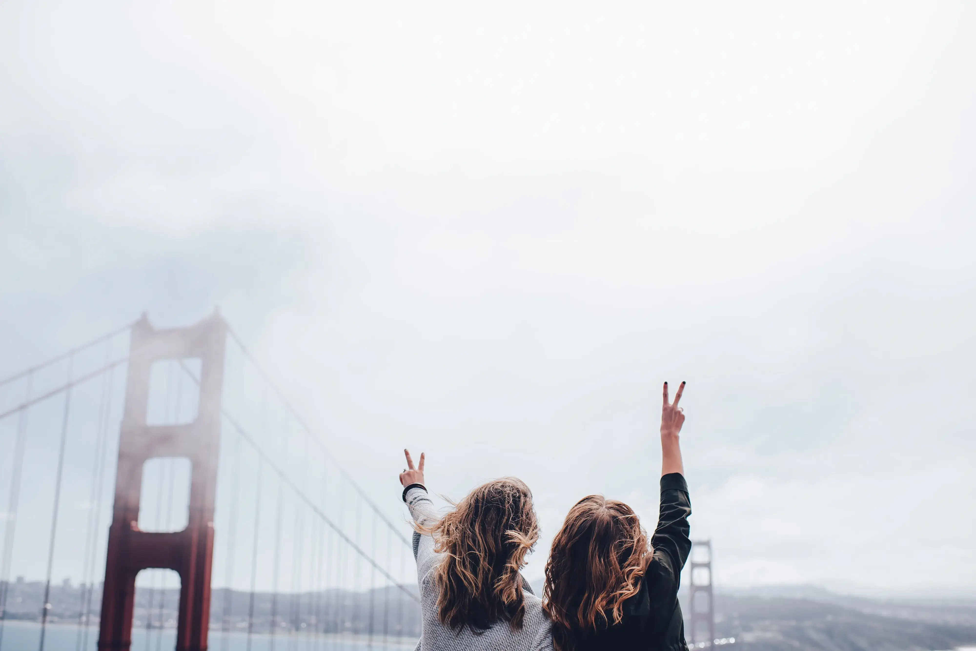 two women overlooking a bridge