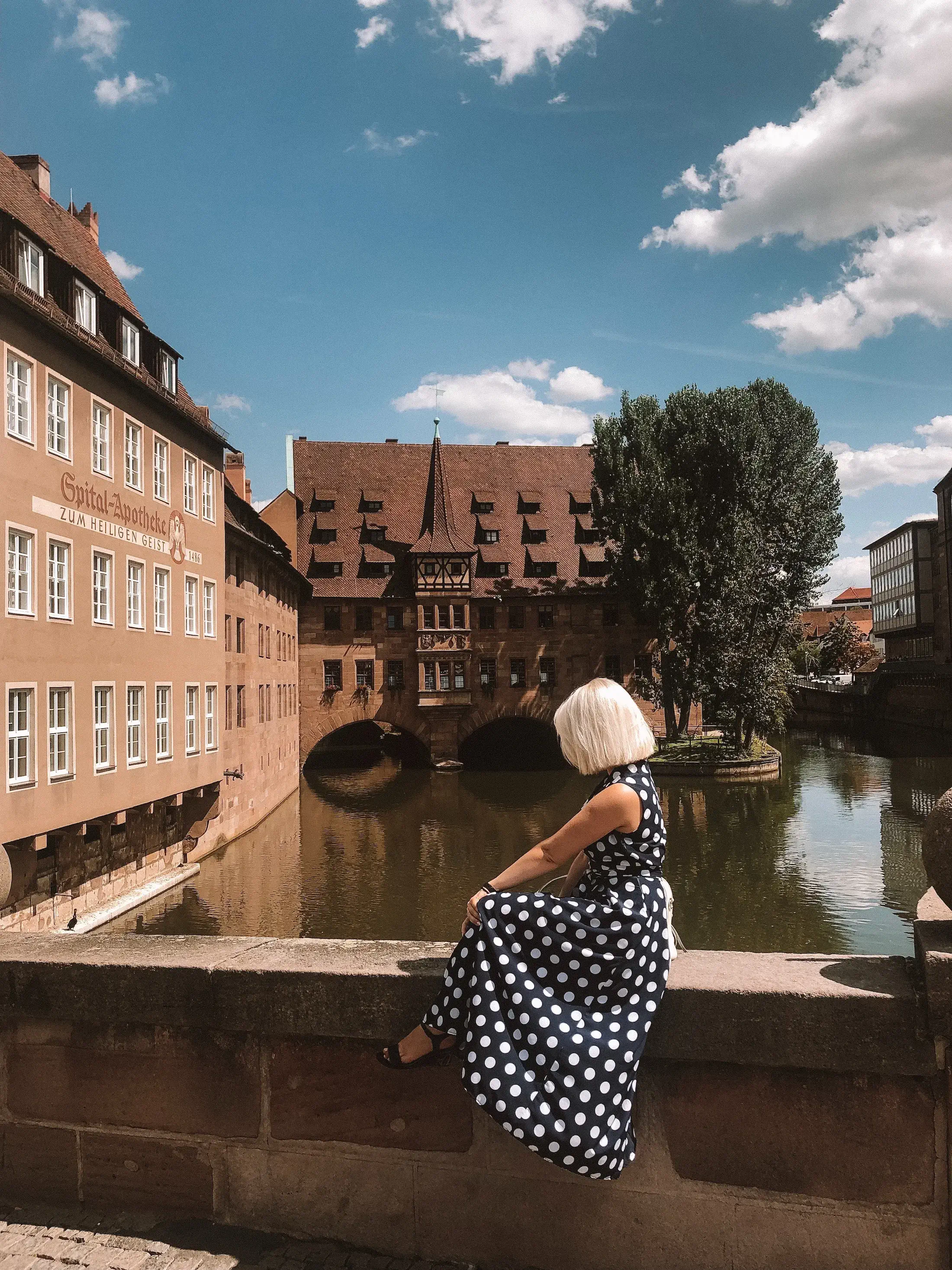 woman sitting on bridge